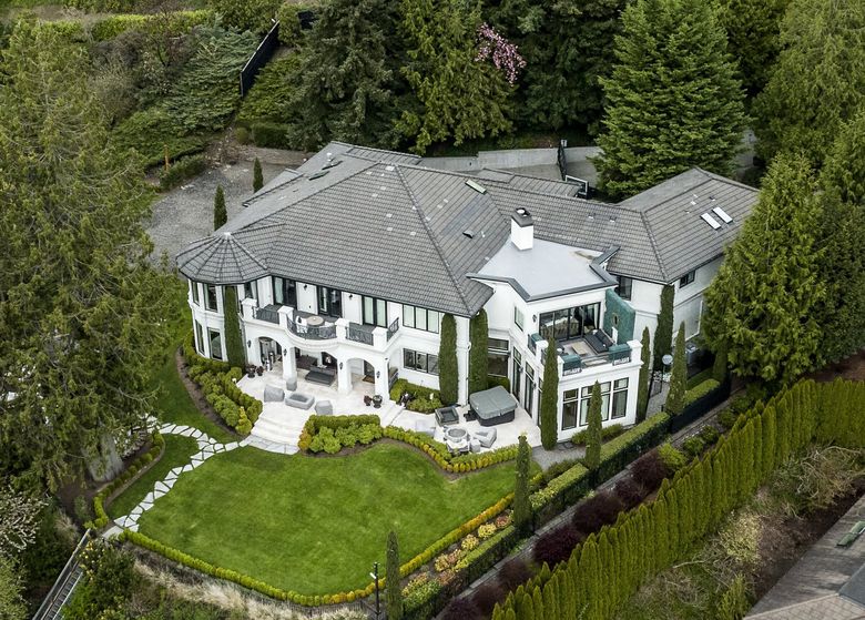 The six-bedroom, 11,000-square-foot waterfront mansion is akin to “resort living.” (Ken Lambert / The Seattle Times)