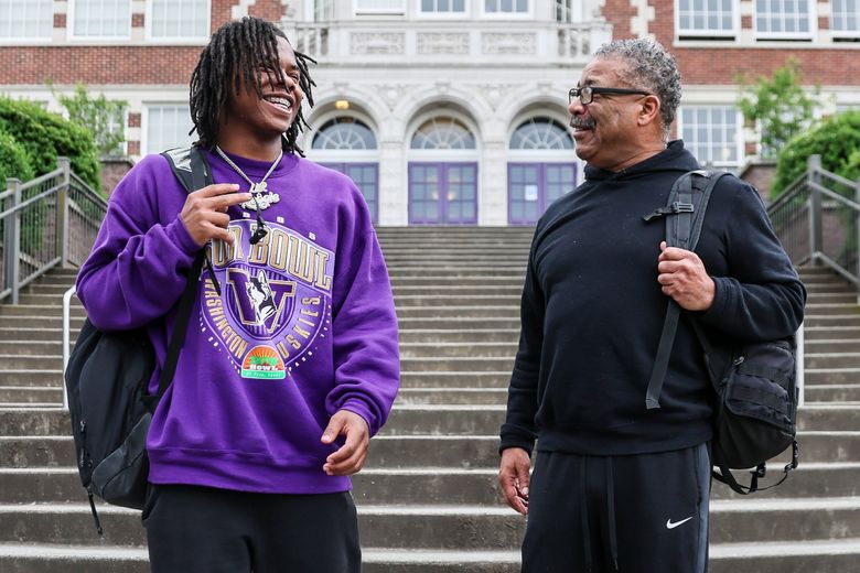 Rahshawn Clark, UW football signee, and his grandfather, JoJo Rodriguez at Garfield High School Monday afternoon in Seattle. (Kevin Clark / The Seattle Times)