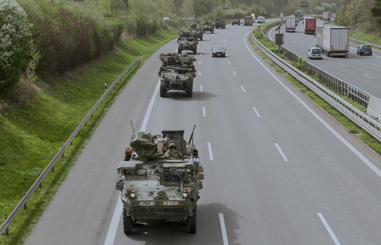 FILE — During NATO exercises, a convoy including Stryker armored combat vehicles heads toward the Polish border in Frankenberg, Germany on April 9, 2024. NATO allies are inching closer to sending troops into Ukraine to train Ukrainian forces, a move that would be another blurring of a previous red line and could draw the United States and Europe more directly into the war. (Laetitia Vancon/The New York Times) XNYT0594 XNYT0594