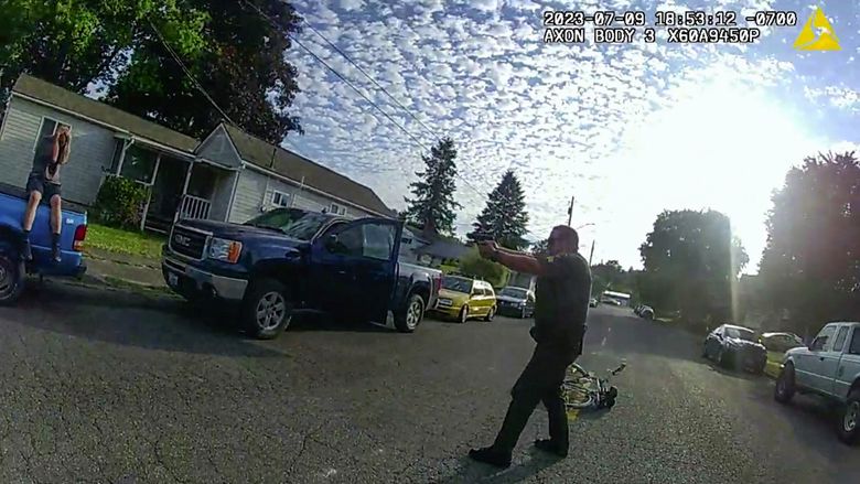 A screenshot from a body camera worn by Deputy Kenneth Fredericksen shows another Snohomish County sheriff’s deputy aiming a gun at Marcus Whybark in Sultan last July. (Snohomish County Sheriff&#8217;s Office)