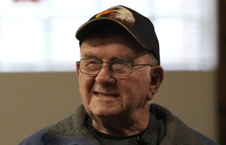 FILE – Earl Meyer, who fought for the U.S. Army in the Korean War, talks with fellow veterans at the American Legion, Nov. 7, 2023, in St. Peter, Minn. On Monday, April 22, 2024, the U.S. Army notified Meyer, who still carries shrapnel in his leg from when he was wounded in combat, that he will finally get his Purple Heart medal, 73 years late. (AP Photo/Abbie Parr, File)
