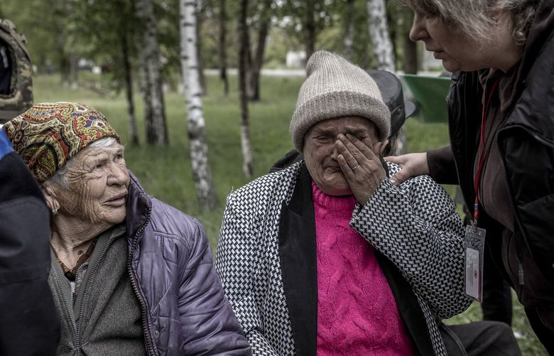 Ukrainian police officers with residents evacuated from Vovchansk, on the way toward the regional capital of Kharkiv, Ukraine, on May 16, 2024. Russia and Ukraine targeted each other’s territory on Sunday with drone attacks and airstrikes that hit urban centers and energy facilities, as both sides look for ways to inflict damage beyond the battlefield. (Finbarr O’Reilly /The New York Times) XNYTF