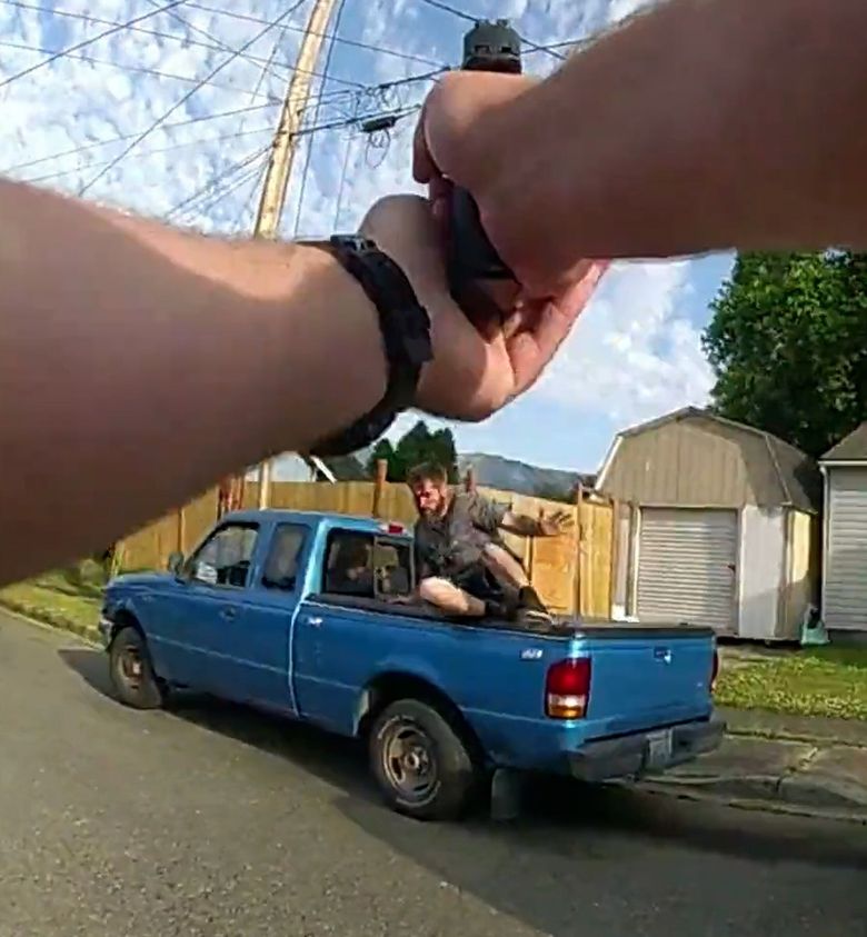 A screenshot from body camera footage worn by Sgt. Carl Whalen shows Marcus Whybark on the back of his girlfriend&#8217;s truck. (Snohomish County Sheriff&#8217;s Department)