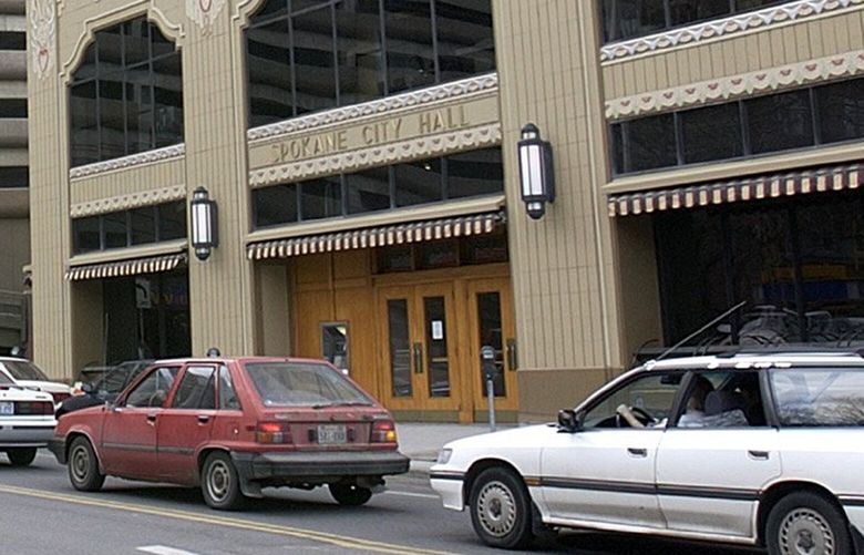 ** ADVANCE FOR MONDAY, MARCH 29 ** Spokane City Hall, right, stands across the street from the River Park Square parking garage Thursday, March 25, 2004, in Spokane, Wash. Barring a settlement, a securities fraud case involving the garage goes before a federal jury next month. The case has influenced Spokane’s political climate and economic fortunes for years. (AP Photo/Jeff T. Green) WAJG103