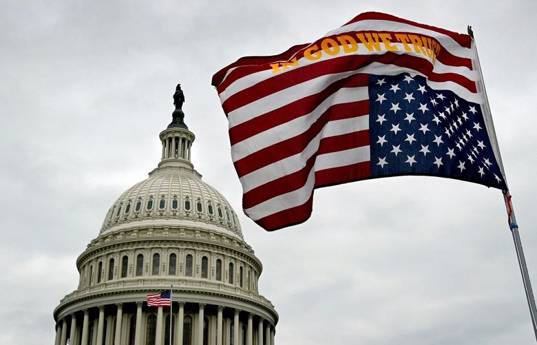 A flag waving upside down in front of the U.S. Capitol grounds on Jan. 6, 2021. MUST CREDIT: Michael S. Williamson/The Washington Post