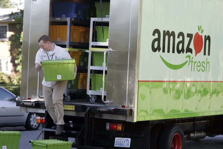 Amazon Fresh driver Tim Wilkie prepares a grocery delivery for a Mercer Island customer in 2007. (AP Photo / Joe Nicholson, 2007)
