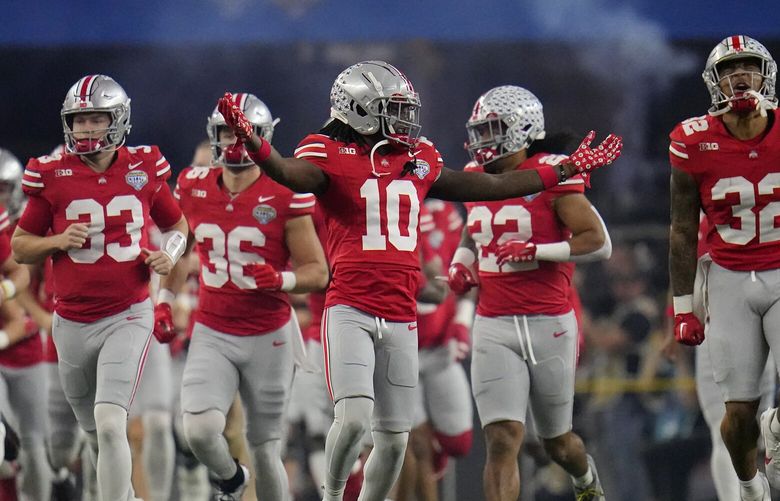 Ohio State players take the field before the Cotton Bowl NCAA college football game against Missouri Friday, Dec. 29, 2023, in Arlington, Texas. (AP Photo/Julio Cortez)