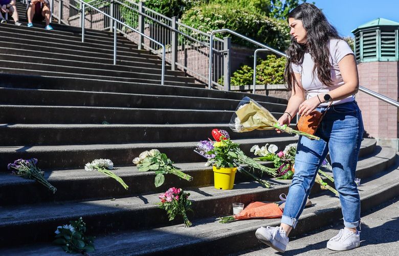 Flowers are added to the growing memorial at the steps of Garfield High School Friday morning in Seattle, Washington, on June 7, 2024.  227155