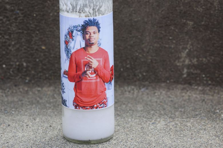 A picture of 17-year-old Amarr Murphy, who played for the Bulldogs’ varsity football team, seen on a candle at a Garfield High memorial in Seattle on Saturday, June 8, 2024. Murphy was shot and killed trying to break up a fight between two boys Thursday afternoon in front of the Quincy Jones Performance Center.  (Ivy Ceballo / The Seattle Times)