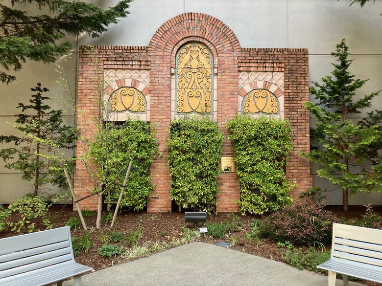 Salvaged polychrome terra-cotta from the Costa Vista apartments was incorporated into the courtyard of Group Health Cooperative (now Kaiser Permanente Washington). The central panel has birds facing each other, surrounded by stylized grape vines with flowers below. (Lawrence Kreisman)