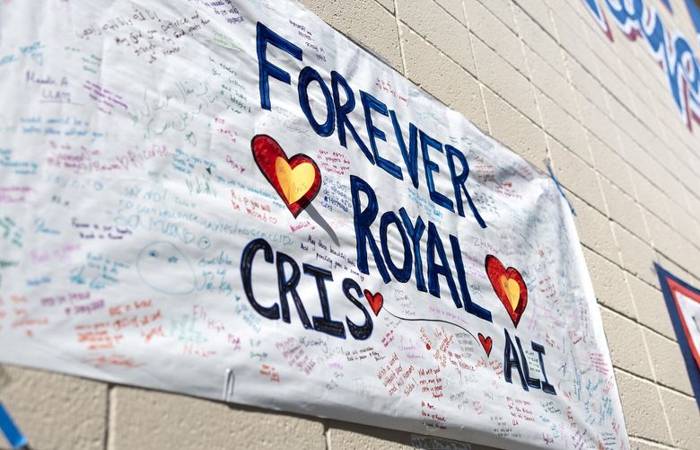 Signs honoring Kent-Meridian student Hazrat Ali Rohani remain affixed to the school building on Wednesday, June 12, 2024, in Kent. Rohani was shot and killed June 5 outside of the Big 5 Sporting Goods in Renton.
