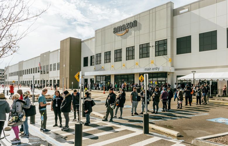 Workers at Amazon’s JFK8 warehouse line up for a unionization vote on Staten Island in New York, March 25, 2022. An affiliation agreement between the Amazon Labor Union and the 1.3-million-member Teamsters signals an escalation in challenging the online retailer. (DeSean McClinton-Holland/The New York Times) 