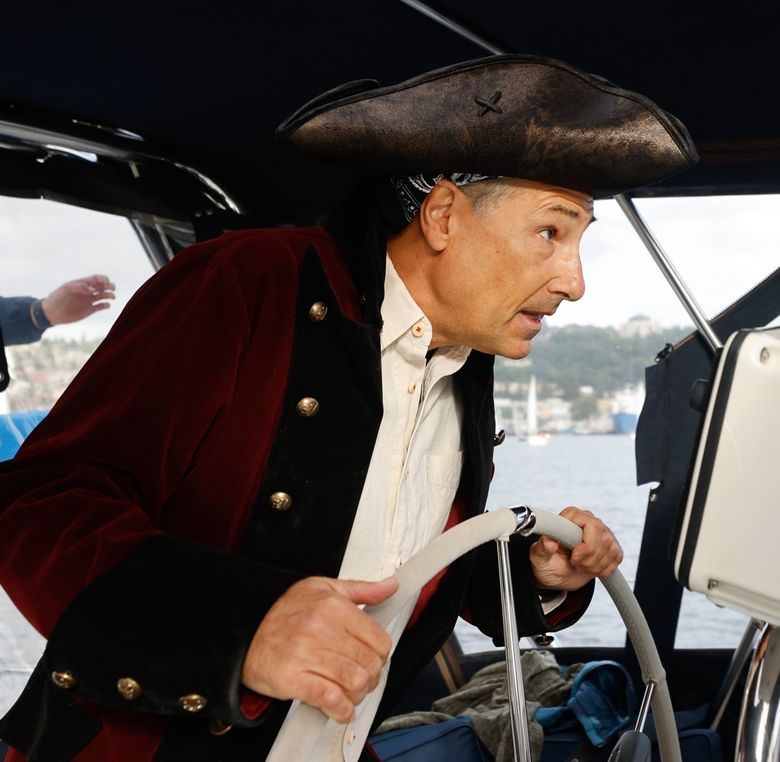 Skipper Mike Panzitta steers the SV Mischief toward the start line in Duck Dodge on Lake Union. (Karen Ducey / The Seattle Times)