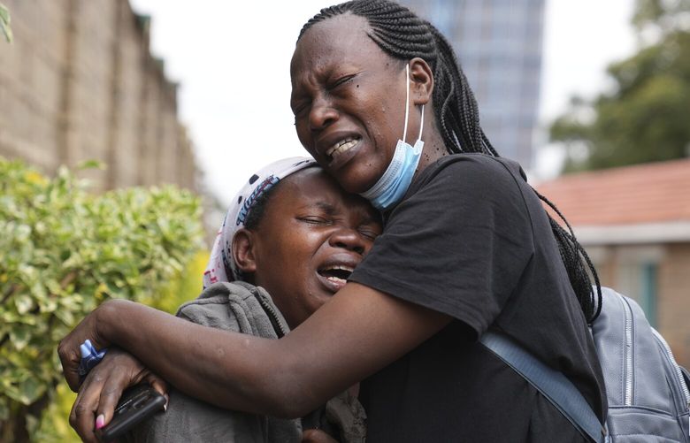 Edith Wanjiku, left, weeps after viewing the body of her son, who was allegedly shot by police during Tuesday’s protest at the Nairobi funeral home, Kenya Wednesday, June 26, 2024. Thousands of protesters stormed and burned a section of Kenya’s parliament Tuesday to protest tax proposals. Police responded with gunfire and several protesters were killed. (AP Photo/Brian Inganga) KBI114 KBI114