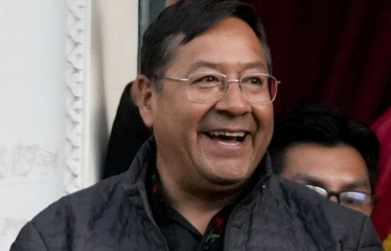 Bolivian President Luis Arce, center, accompanied by Vice President David Choquehuanca, right, acknowledge supporters as they stand on a balcony of the government palace in La Paz, Bolivia, Wednesday, June 26, 2024. Armored vehicles rammed the doors of Bolivia’s government palace Wednesday in an apparent coup attempt against Arce, but he vowed to stand firm and named a new army commander who ordered troops to stand down. (AP Photo/Juan Karita) XNP131 XNP131