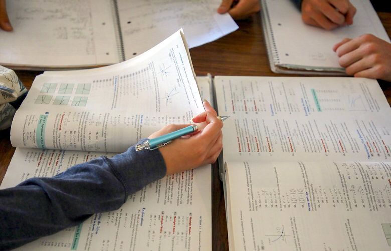 FILE — Students during a math class at George Washington High School in San Francisco, on Oct. 27, 2021. Two new studies suggest that pandemic aid — the largest single federal investment in U.S. schools —improved student test scores, but only modestly. (Jim Wilson/The New York Times) XNYT0376