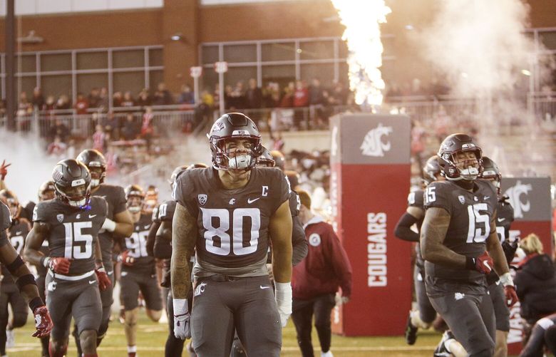Washington State defensive end Brennan Jackson (80) and his teammates run onto the field before an NCAA college football game against Colorado, Friday, Nov. 17, 2023, in Pullman, Wash. (AP Photo/Young Kwak) OTK