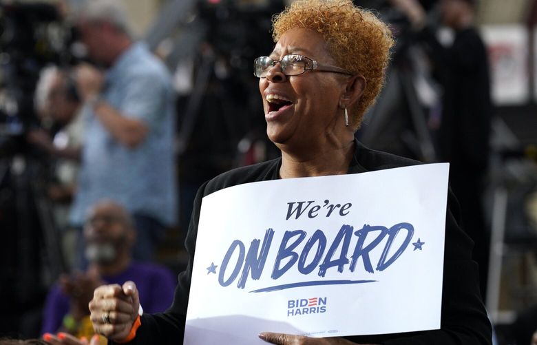 FILE – A supporter of President Joe Biden holds a sign during a reelection campaign event in Philadelphia on May 29, 2024. Black Democratic women are Biden’s most consistent voters. (Yuri Gripas/The New York Times) XNYT0680 XNYT0680