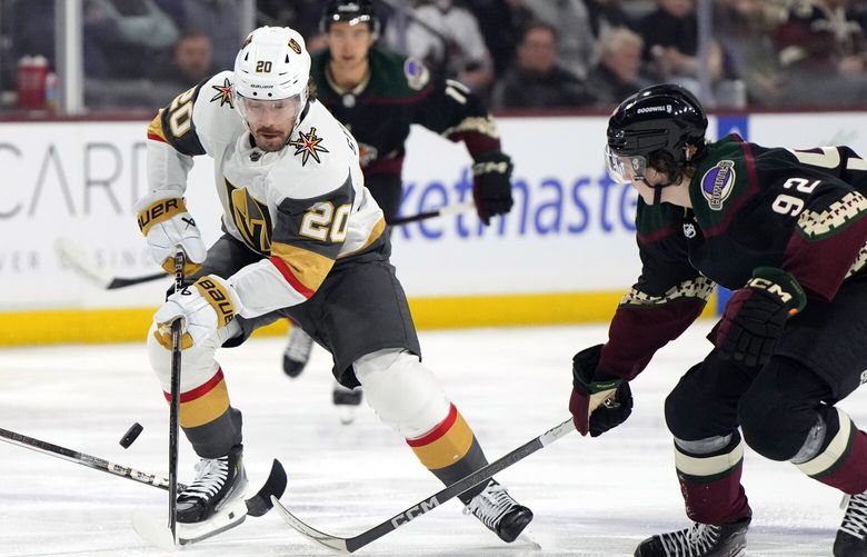 Vegas Golden Knights center Chandler Stephenson skates by Arizona Coyotes center Logan Cooley (92) in the second period during an NHL hockey game, Thursday, Feb. 8, 2024, in Tempe, Ariz. (AP Photo/Rick Scuteri)