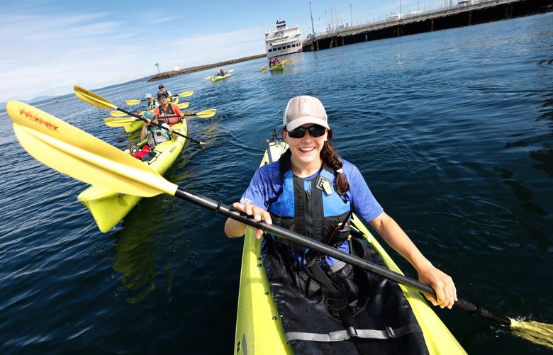Anna Goddu, a guide with Ballard Kayak & Paddleboard leads a tour from the Shilshole Marina to the Ballard Locks in Seattle on Saturday, June 29, 2024. “No matter what there’s always something to see,” says Anna.