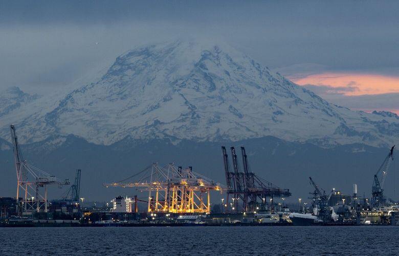 Mt. Rainier looms over the Port of Seattle Tuesday, Nov. 21, 2023, in Seattle.