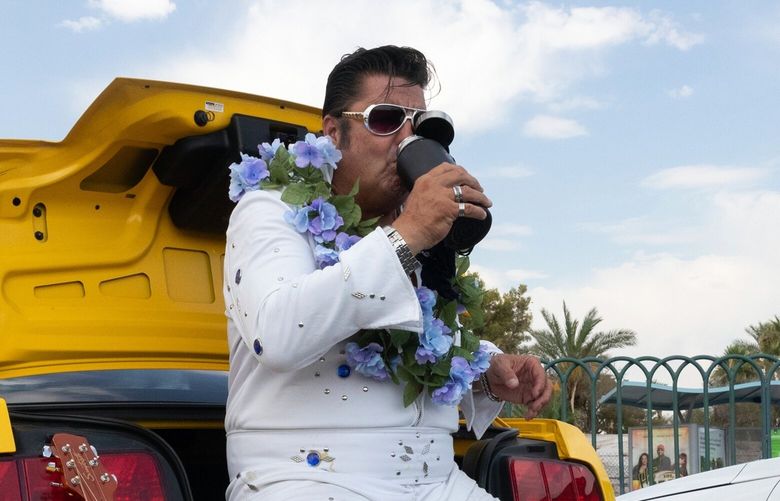 An Elvis impersonator in Las Vegas on Thursday, July 11, 2024.  More than 60 million Americans were under heat alerts from the National Weather Service on Thursday. (Mikayla Whitmore/The New York Times) XNYT0300 XNYT0300