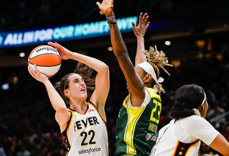 Indiana&#8217;s Caitlin Clark scores over the Storm&#8217;s Jordan Horston during the fourth quarter, May 22, at Climate Pledge Arena in Seattle. (Dean Rutz / The Seattle Times)