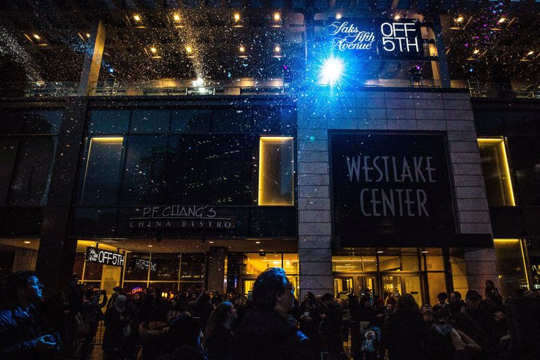 A snow machine dusts snow on the crowd during the annual tree lighting ceremony at Westlake Center. Downtown Seattle&#8217;s Saks OFF 5th, a spinoff of Saks Fifth Avenue, will close July 20. (Rebekah Welch / The Seattle Times, 2018)