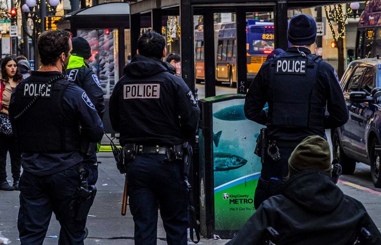 Seattle Police Department officers patrol downtown at Third Avenue and Pike Street on Tuesday, Feb. 22, 2023.