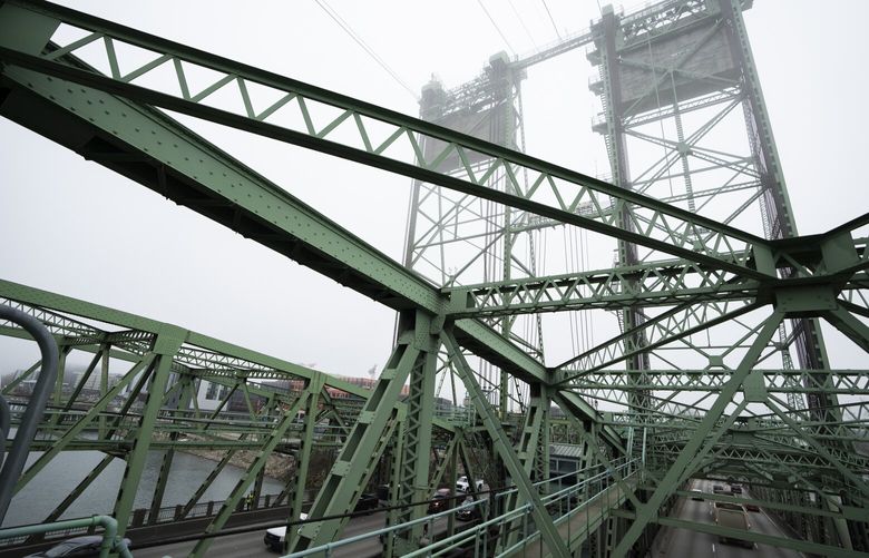 Traffic moves along the Interstate 5 bridge that spans the Columbia River and connects Portland, Ore., with southwest Washington state is seen on Tuesday, Feb. 13, 2024. The bridge is set to be replaced as part of a multibillion-dollar project supported by federal funding. (AP Photo/Jenny Kane) WAJKOTK WAJKOTK