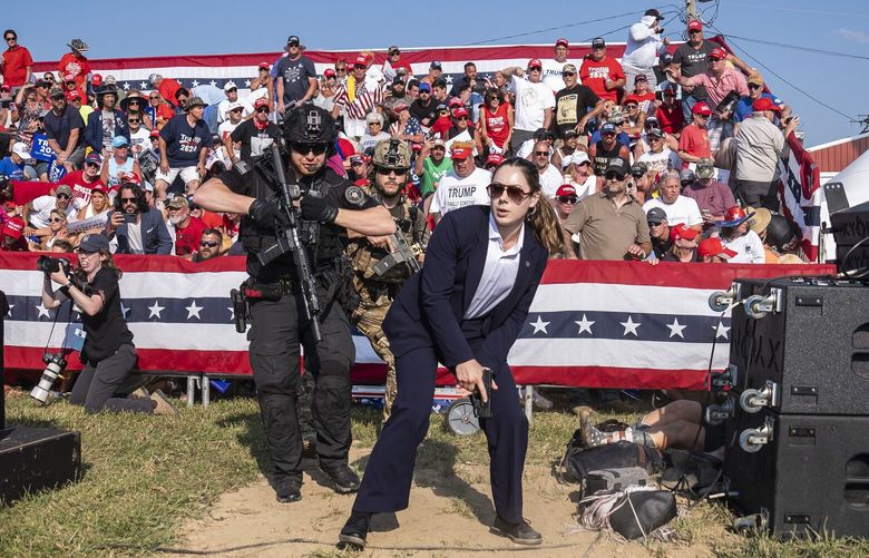 Secret Service agents react as shots are fired toward Donald Trump on Saturday in Pennsylvania. MUST CREDIT: Jabin Botsford/The Washington Post