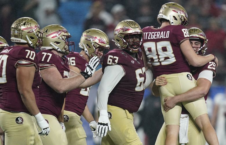 Florida State kicker Ryan Fitzgerald (88) is lifted by Alex Mastromanno after kicking a field goal against Louisville during the second half of the Atlantic Coast Conference championship NCAA college football game Saturday, Dec. 2, 2023, in Charlotte, N.C. (AP Photo/Erik Verduzco)