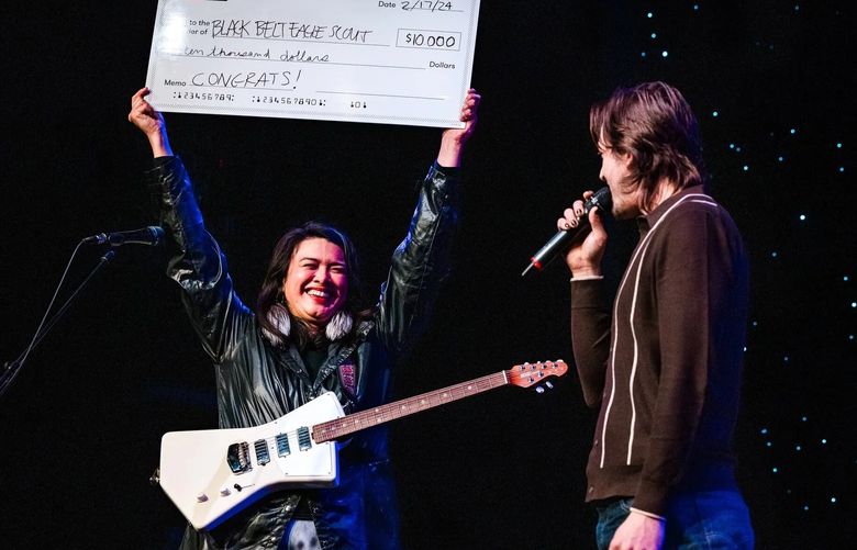 Katherine “KP” Paul receives a check from Sonic Guild for her project Black Belt Eagle Scout. Sonic Guild provides grants intended for musicians to put toward career expenses — things like costly studio time, making music videos or buying new gear — though it’s not set in stone. (Jake Hanson)