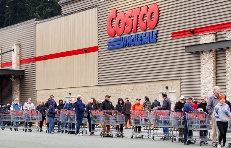 Taking advantage of early morning shopping hours for senior citizens, customers line up three building lengths on Thursday morning to get their chance to shop at the Lynnwood Costco across the street from the Alderwood Mall. Toilet paper was limited to one package per customer. People were told to stay six-feet apart from the next person in line to help battle coronavirus. 

Photographed on March 26, 2020. 213468