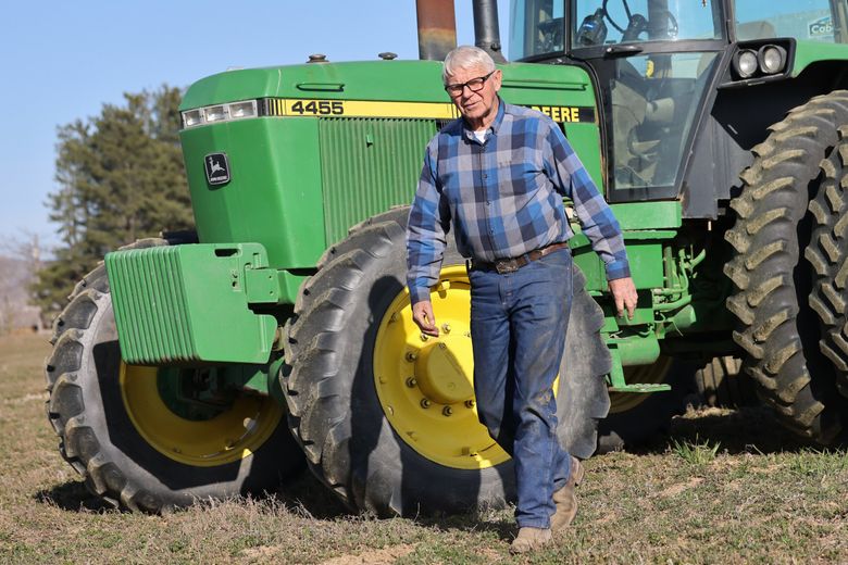 Murray Van Dyke tends to his family  alfalfa farm in Quincy. Van Dyke, who spoke at a public meeting about power rates,  worries rate hikes will affect his and others&#8217; ability to continue farming in the area. (Karen Ducey / The Seattle Times)