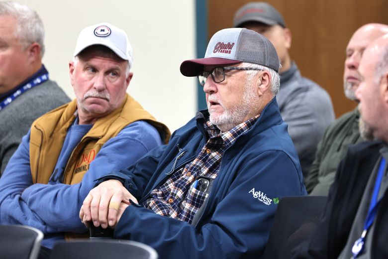  Farmer John Stahl, center right, speaks at a Grant County Public Utility District meeting in Ephrata in November last year. Commissioners and attendees discussed raising power rates. (Karen Ducey / The Seattle Times)