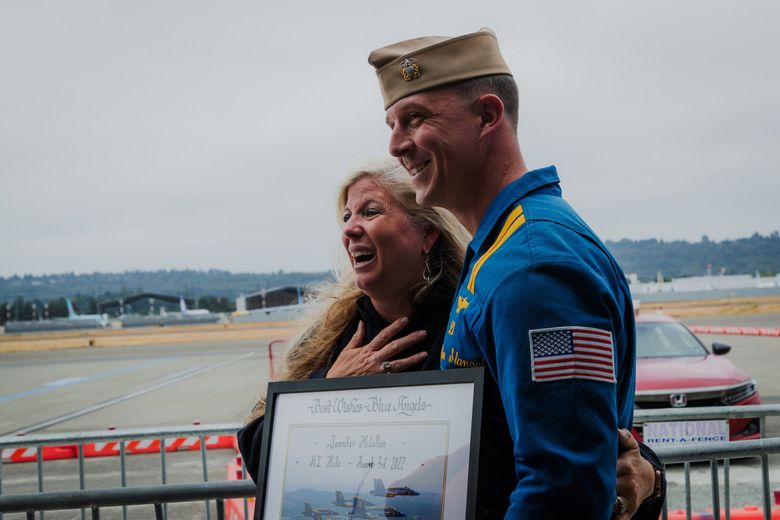 Mercer Island High School teacher Jen McClellan takes a photo with Lt. Griffin Stangel of the Blue Angels after a media flight during a Seafair press event in 2022. (Kori Suzuki / The Seattle Times, 2022)