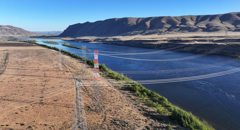 Enormous high-voltage power lines stretch across the Columbia River at Wanapum Dam, one of two major sources of hydroelectricity for the Central Washington farming community of Grant County. (Karen Ducey / The Seattle Times)