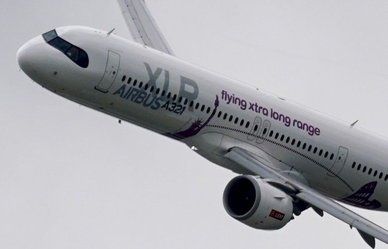 An Airbus A321-253 XLR flies, at the Farnborough International Air Show in Farnborough, England, Monday, July 22, 2024. (AP Photo/Alberto Pezzali) 