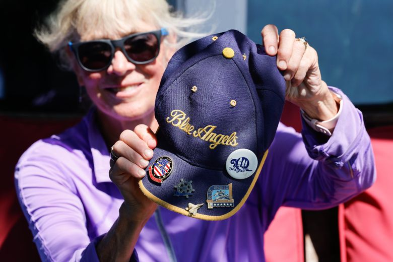 Leslie Crow shows off a Blue Angels hat outside her Seattle home on Friday, July 19, 2024. (Karen Ducey / The Seattle Times)