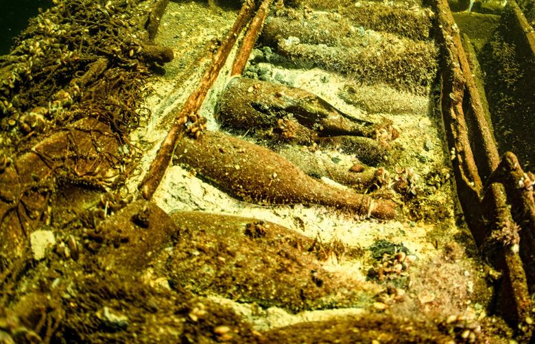 A team of divers inspect a 19th-Century wreck laden with 100 bottles of champagne about 20 nautical miles (37 kilometers) south of the Swedish island of ÷land. MUST CREDIT: Tomasz Stachura/Baltictech