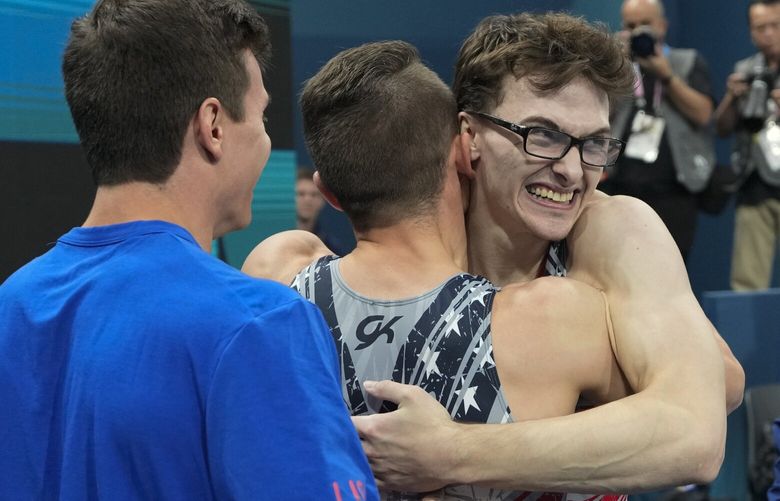 Stephen Nedoroscik, of United States, gets a hug from Paul Juda after last rotation during the men’s artistic gymnastics team finals round at Bercy Arena at the 2024 Summer Olympics, Monday, July 29, 2024, in Paris, France. (AP Photo/Abbie Parr) OLYMG288 OLYMG288