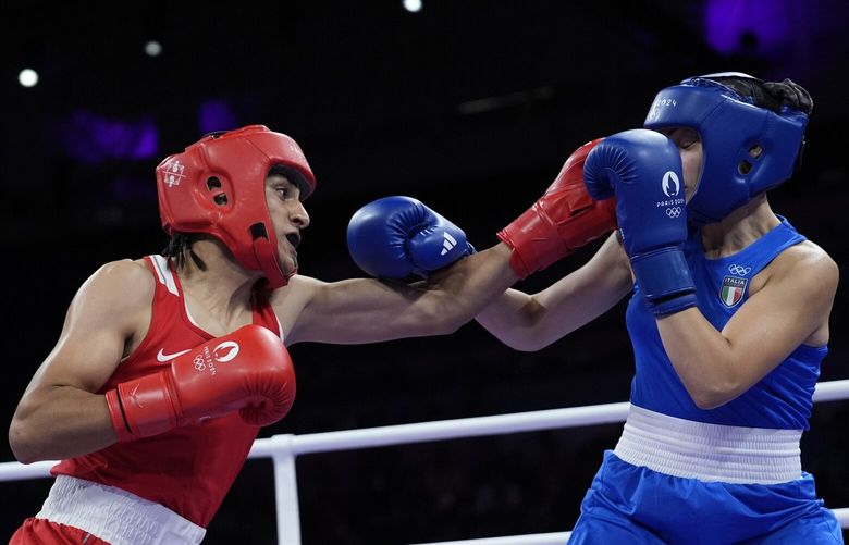 Algeria’s Imane Khelif, left, fights Italy’s Angela Carini in their women’s 66kg preliminary boxing match at the 2024 Summer Olympics, Thursday, Aug. 1, 2024, in Paris, France. (AP Photo/John Locher) OLYXAC157 OLYXAC157