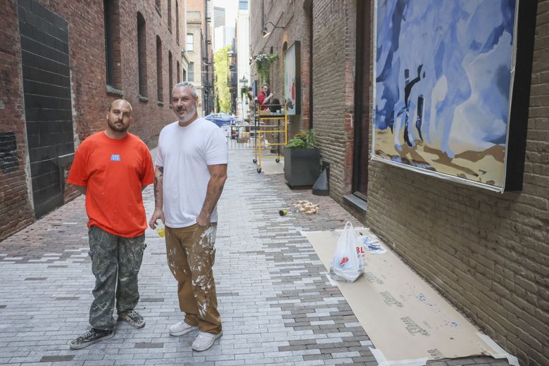 Arts organizers Dom Nieri, left, of ARTXIV, and Gage Hamilton of Forest For The Trees. The two organizations are among those presenting murals in downtown Seattle this summer. (Ivy Ceballo / The Seattle Times)