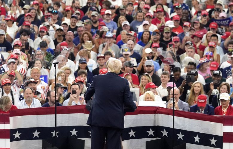 FILE – Republican presidential candidate former President Donald Trump speaks at a campaign rally in Atlanta, Aug. 3, 2024. Trump and Vice President Kamala Harris held dueling Georgia rallies four days apart, but the dynamics showcased how deeply divided the American electorate is. The Harris crowd was majority Black and female. Trump’s crowd was overwhelmingly white. They listened to different music. They heard wildly different arguments on immigration, the economy, voting rights. Either Harris or Trump will win. The question is how widely the winner will be accepted. (AP Photo/John Bazemore, File) WX506 WX506