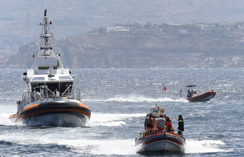 Emergency services at the scene of the search for a missing boat, in Porticello, southern Italy, Tuesday, Aug. 20, 2024. Rescue teams and divers returned to the site of a storm-sunken superyacht Tuesday to search for six people, including British tech magnate Mike Lynch, who are believed to be still trapped in the hull 50 meters (164-feet) underwater. (AP Photo/Salvatore Cavalli) XSC114 XSC114