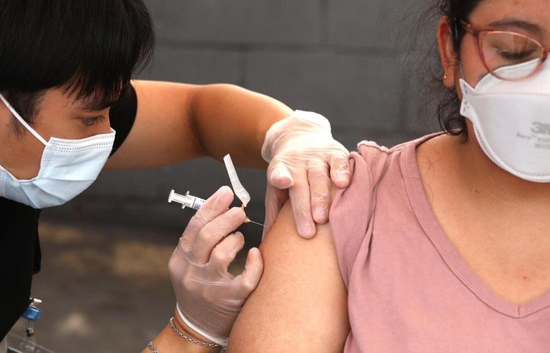 LYNNWOOD, CA – SEPTEMBER 22, 2023 – USC graduate and pharmacy student Jordan Gelacio gives Aura Viva a free flu shot at a vaccine clinic provided by the L.A. Care and Blue Shield of California Promise Health Plans at the Community Resource Center in Lynnwood on September 22, 2023. According to Hector Andrade, with L.A. Care and Blue Shield of California, they were not able to get COVID-19 vaccines for this clinic. They hope to have some by next week for other clinics. They are hosting10 walk-in vaccine clinics at their jointly operated Community Resource Centers across Los Angeles County, providing members and the public with no-cost flu and upcoming COVID-19* vaccines. Visitors also had their blood pressure checked and blood sugar measured. The vaccine clinics will take place from September 22 to October 20, 2023. (Genaro Molina / Los Angeles Times) 119478380P