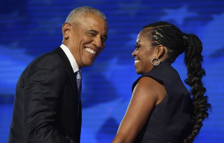 Former President Barack Obama hugs former first lady Michelle Obama as he is introduced during the Democratic National Convention Tuesday, Aug. 20, 2024, in Chicago. (AP Photo/Erin Hooley) DNC769 DNC769