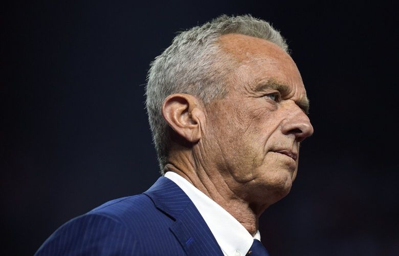 Independent presidential candidate Robert F. Kennedy Jr. listens before endorsing Republican presidential nominee former President Donald Trump at a campaign rally at the Desert Diamond Arena, Friday, Aug. 23, 2024, in Glendale, Ariz. (AP Photo/Evan Vucci) AZEV402 AZEV402