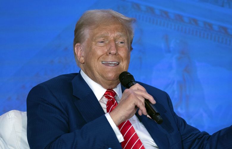 Republican presidential nominee former President Donald Trump speaks with Moms for Liberty co-founder Tiffany Justice during an event at the group’s annual convention in Washington, Friday, Aug. 30, 2024. (AP Photo/Jose Luis Magana) DCJL117 DCJL117